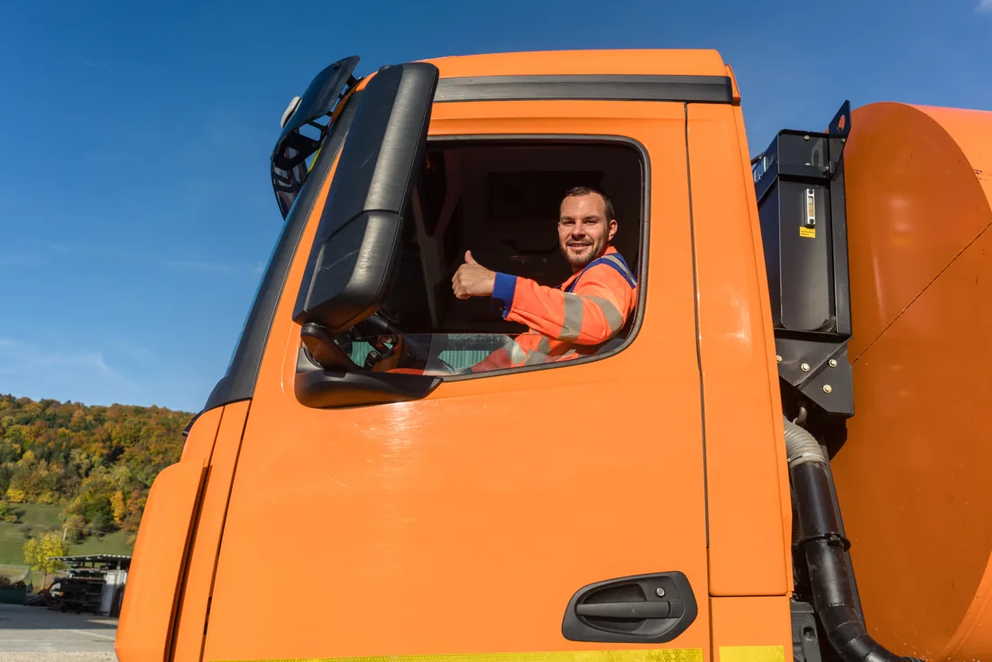 Truck driver in an orange cab